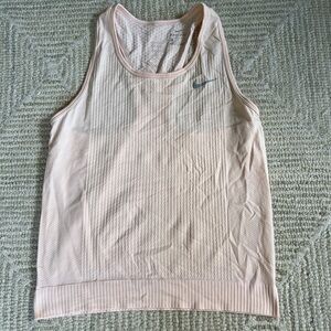 Light orange nike tank top. texture on the tank. super cute and comfy